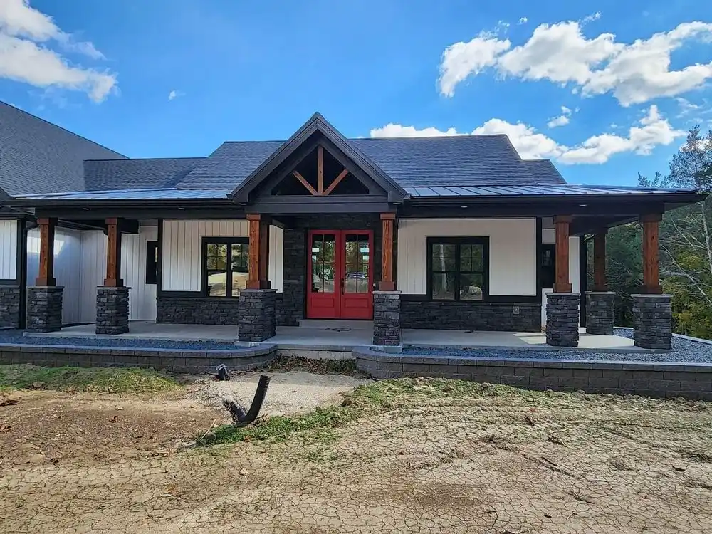 New farmhouse-style home with large front windows and a red double door