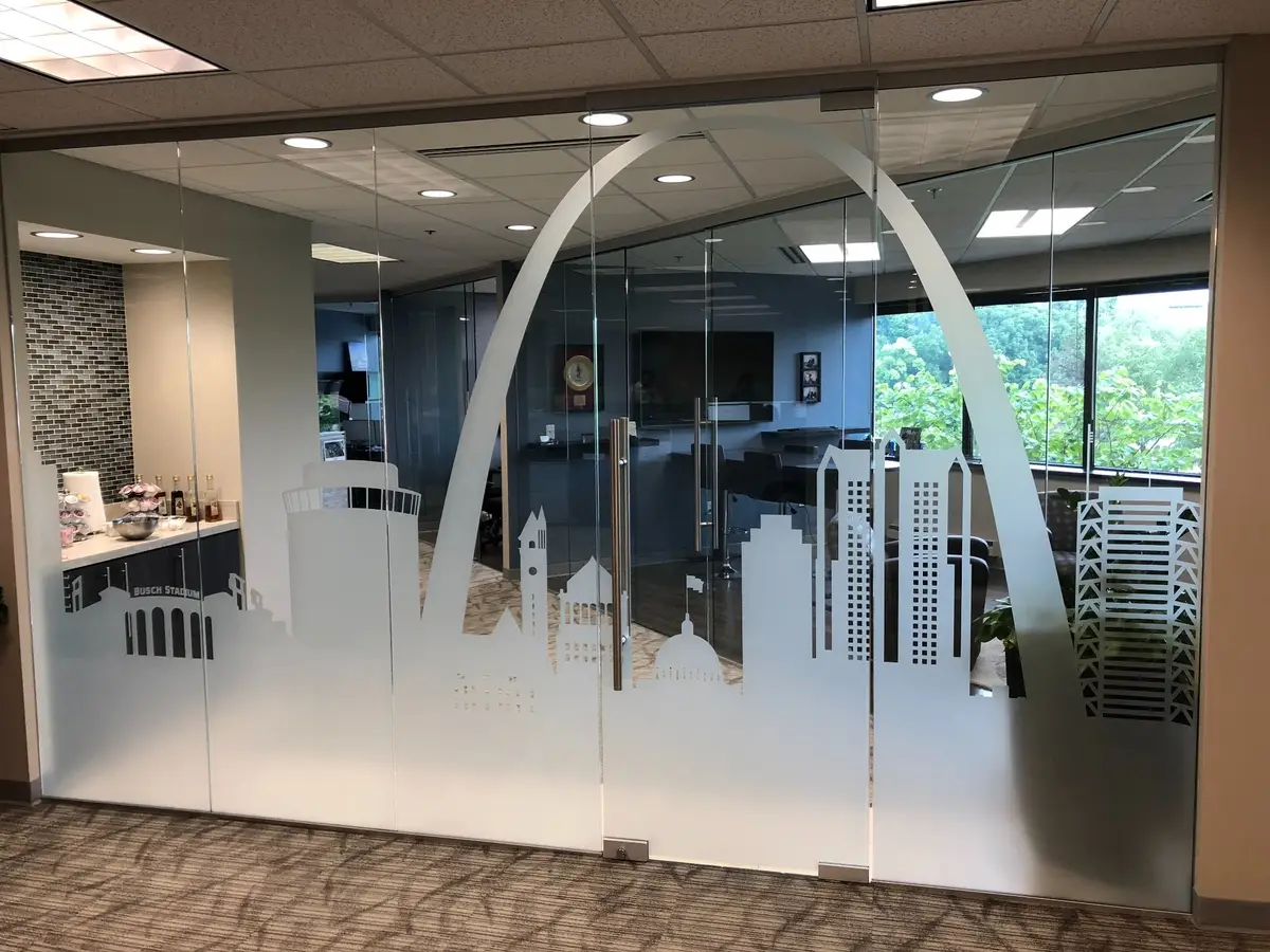 Office glass wall with frosted decorative film showing the Gateway Arch and skyline